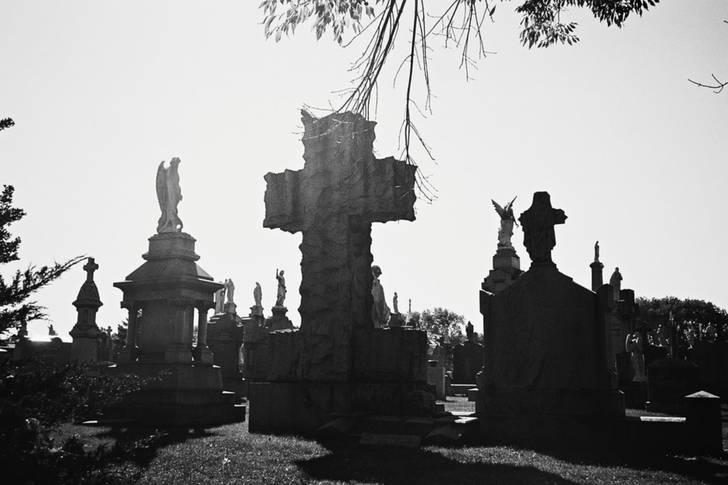 a black and white photo of a cemetery in Queens
